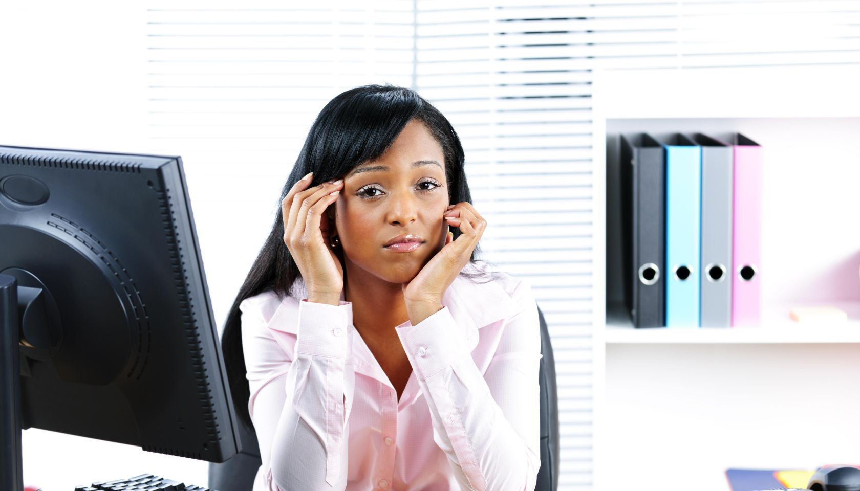 Worried black businesswoman at desk