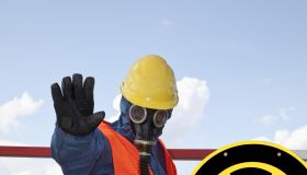 Germany, Man in protective workwear near radioactive warning symbol