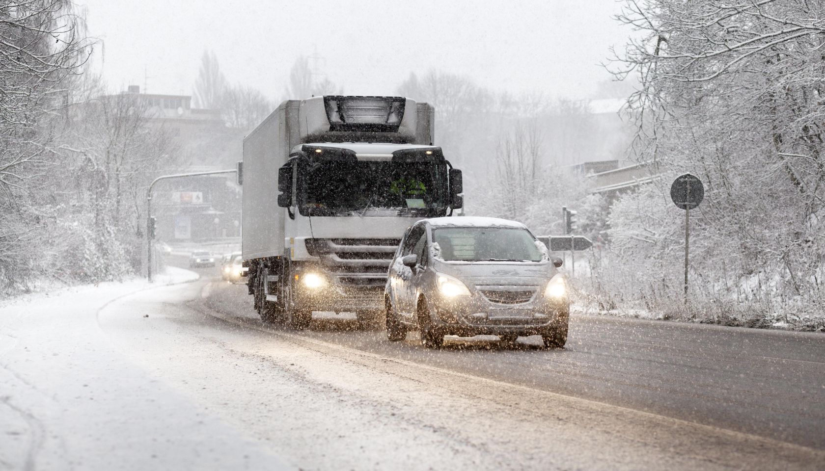 Traffic on road moving slowly in heavy winter snowfall