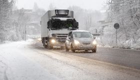 Traffic on road moving slowly in heavy winter snowfall