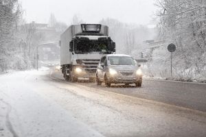 Traffic on road moving slowly in heavy winter snowfall
