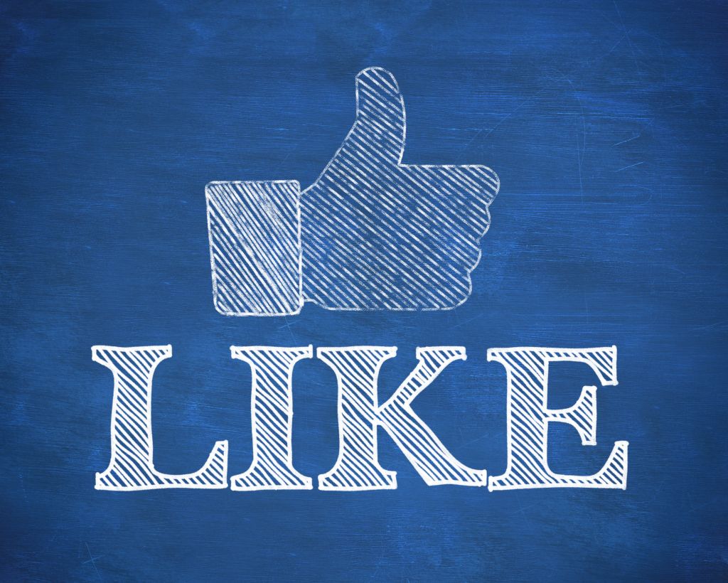 Thumb up representing social network logo above the word like written on blue background