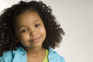 Portrait of young girl (4-5) smiling, studio shot