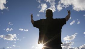 Man raising arms toward the sky