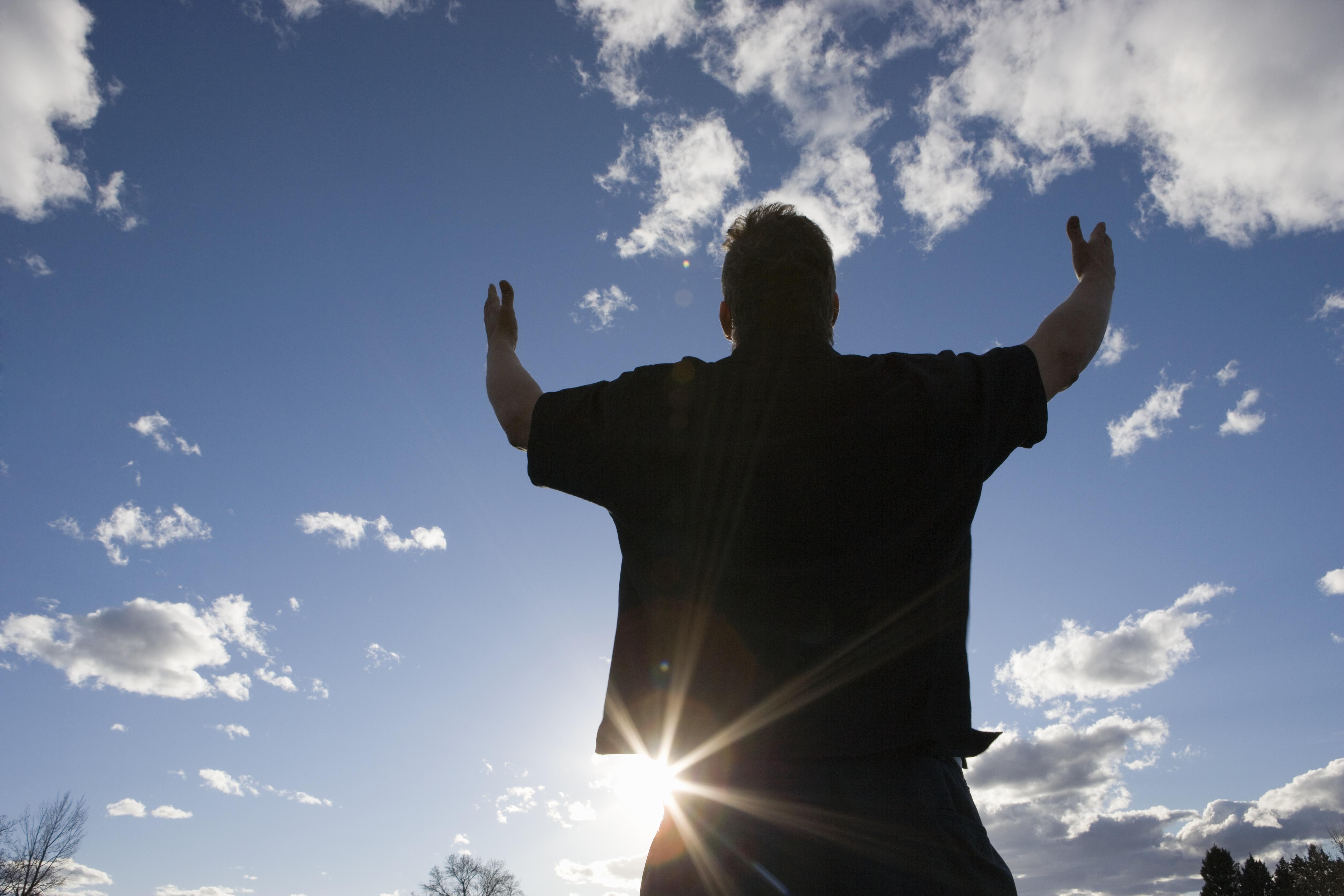 Man raising arms toward the sky