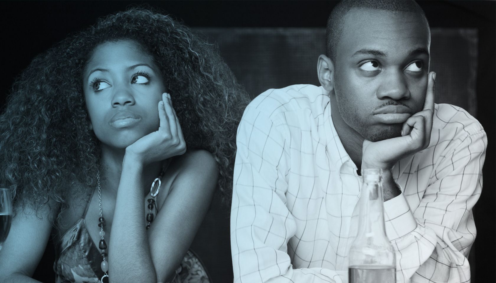 Couple sitting at bar and looking irritated