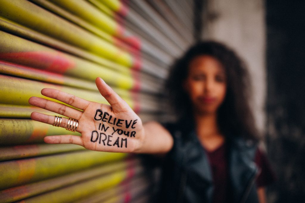 African American girl with inspirational meassage written on her hand