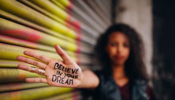 African American girl with inspirational meassage written on her hand