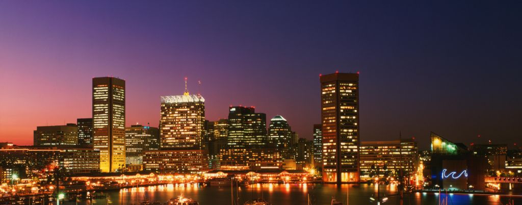 USA, Maryland, Baltimore skyline and harbour at dusk