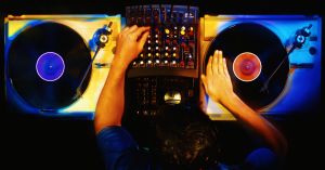 Disc jockey working with vinyl records, overhead view