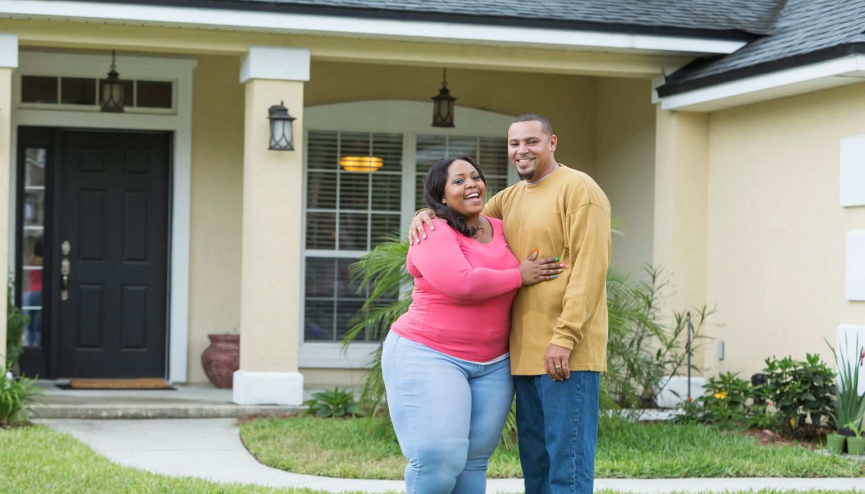 Young African American couple outside home