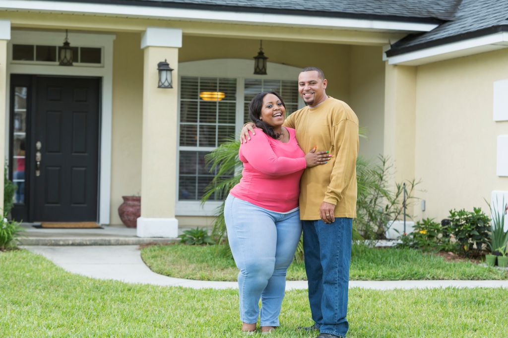 Young African American couple outside home