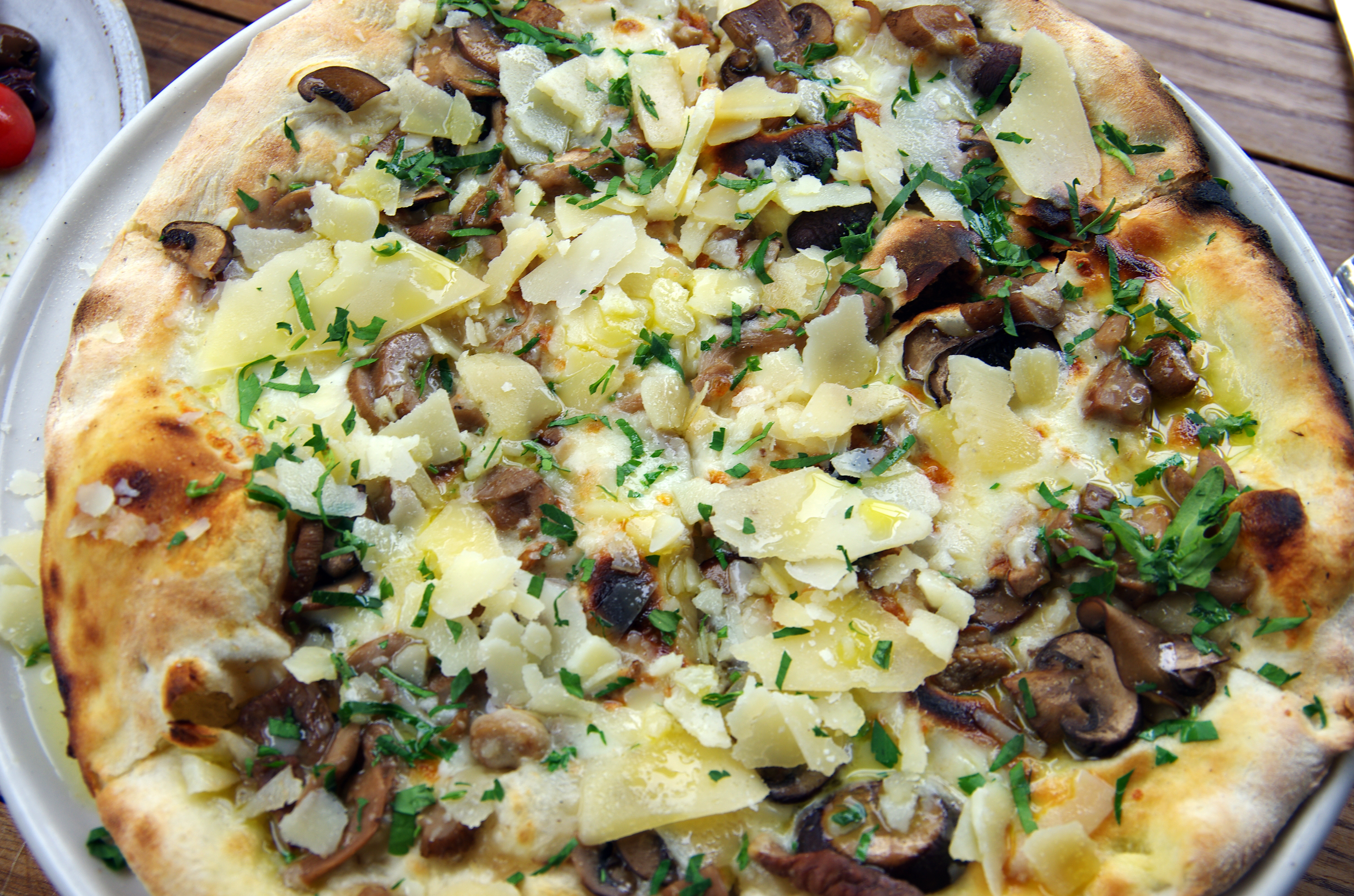 Funghi pizza with fior di latte (cow's milk mozzarella cheese), wild mushrooms, parmesan, truffle oil and fresh parsley