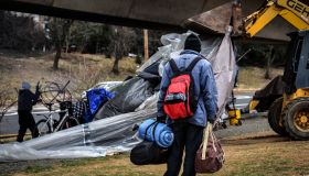 Authorities clear out a homeless tent encampment beneath the Whitehurst freeway, in Washington, DC.