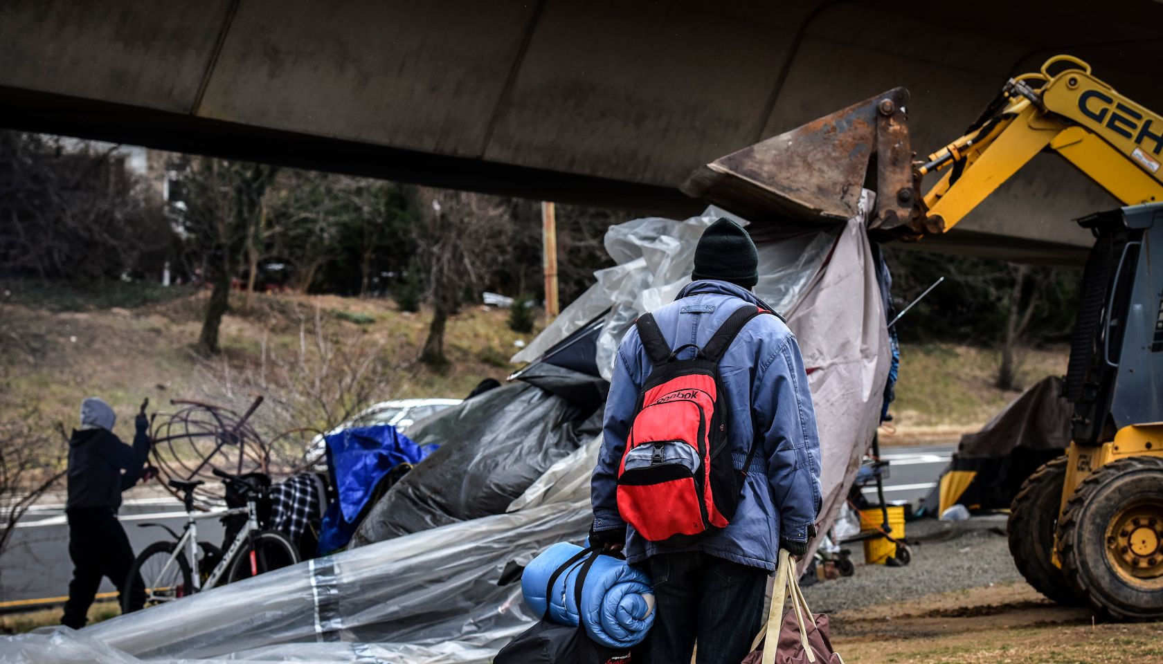 Authorities clear out a homeless tent encampment beneath the Whitehurst freeway, in Washington, DC.