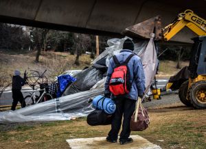 Authorities clear out a homeless tent encampment beneath the Whitehurst freeway, in Washington, DC.