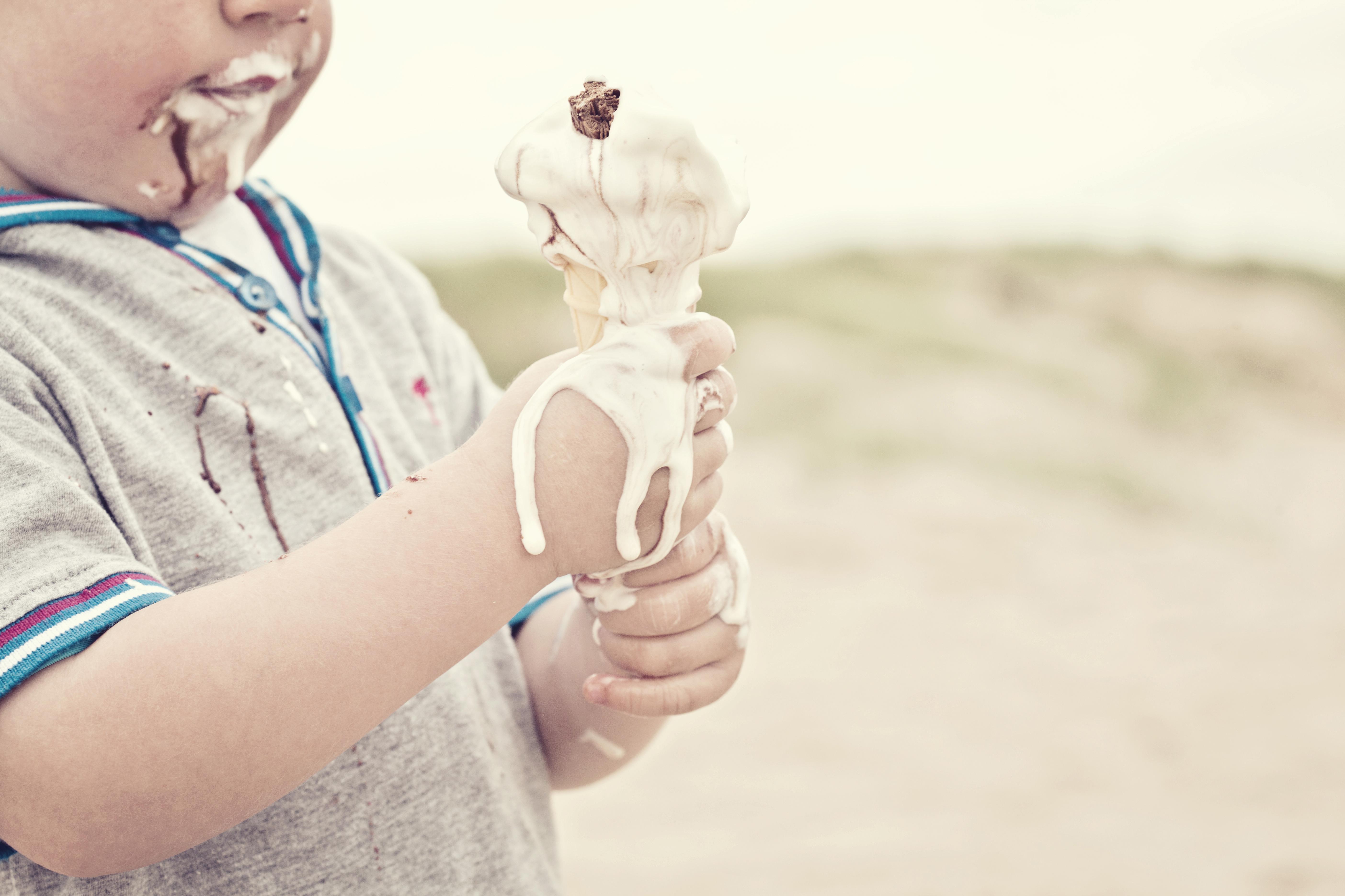 Child eating melted ice cream