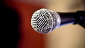 Close up of metal microphone against defocused background