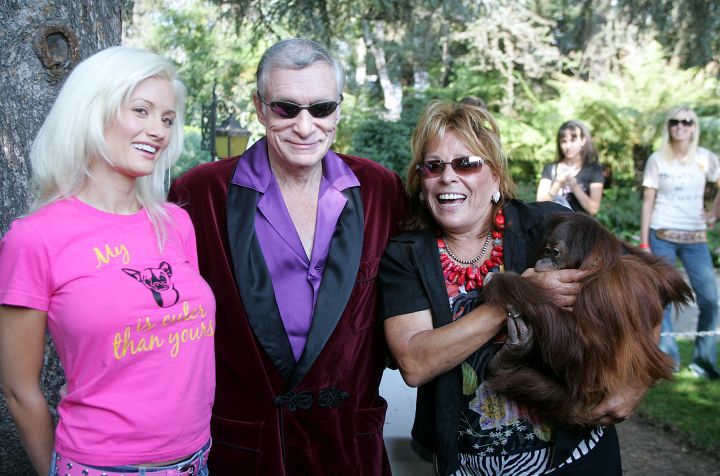 Hugh Hefner, king of the Playboy empire,center, poses with Playmate ,Holly Madison, left, and Marti