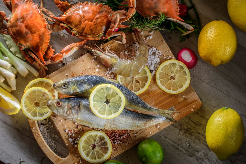 Fresh Fish and Shell Fish with sea salt and spices on cutting board
