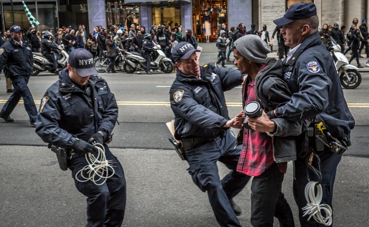 Policemen Arrest a Protester atan Anti-Trump Rally.