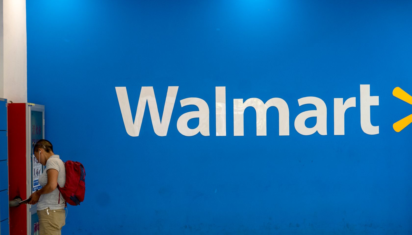 A man is taking his belongings in Walmart lockers.