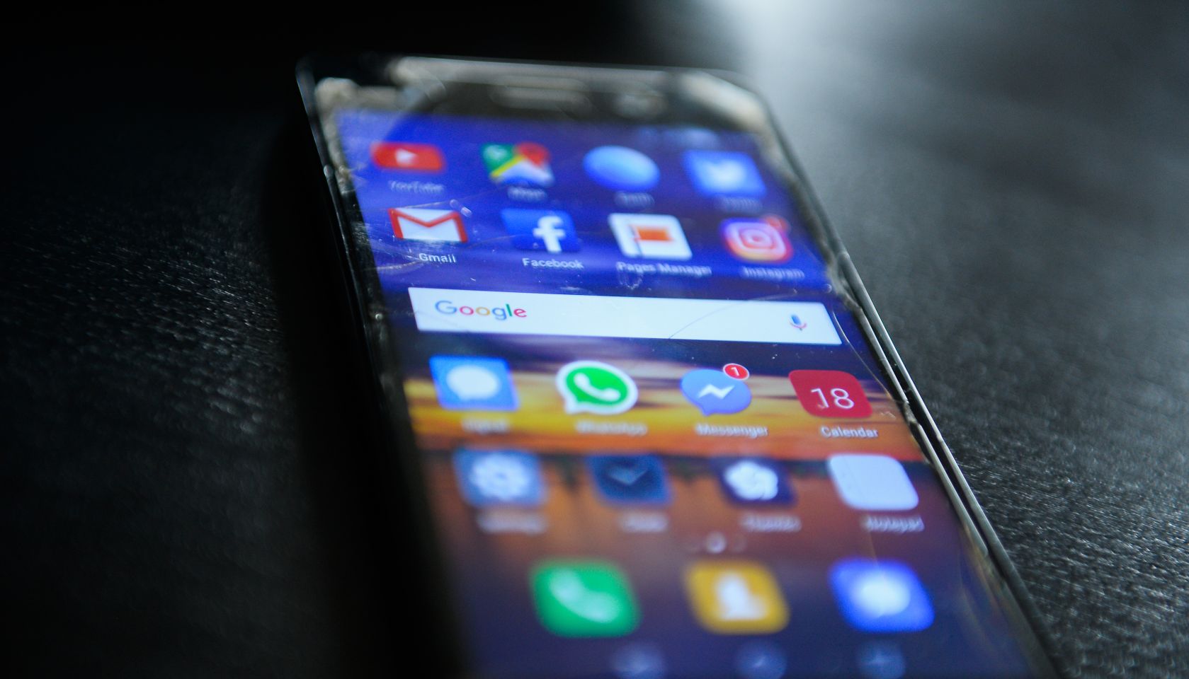 Social media icons are seen in a mobile device...