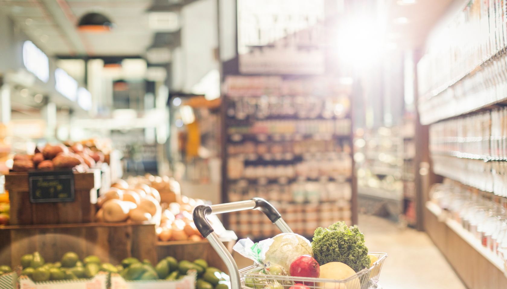 Fresh produce in shopping cart in grocery store market