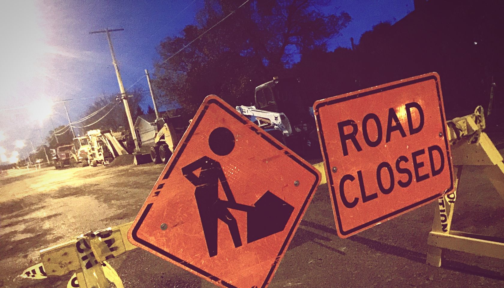 Road Closed Sign On Barricade At Night