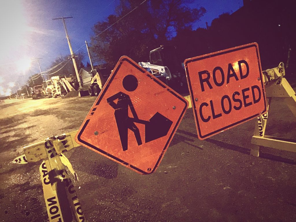 Road Closed Sign On Barricade At Night