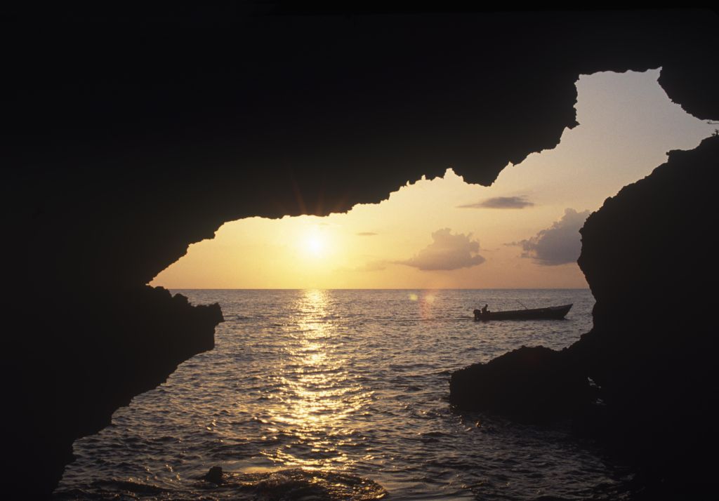 Sunset at one of the five sea caves' opening at Xtabi.