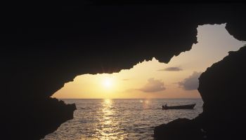 Sunset at one of the five sea caves' opening at Xtabi.