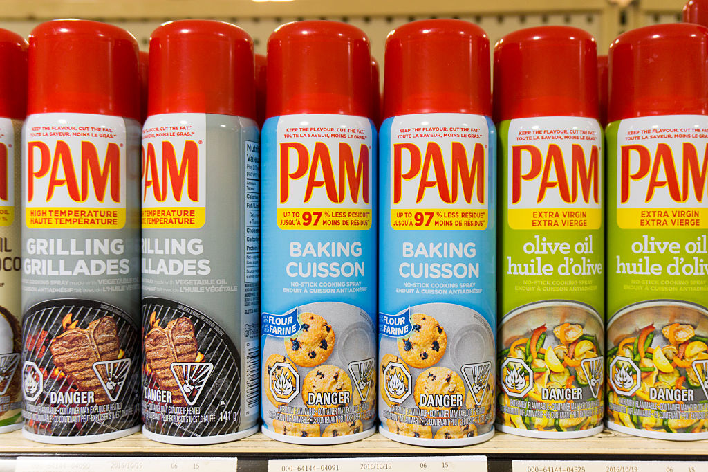 PAM: cooking sprays in store shelf. PAM is a brand name by...