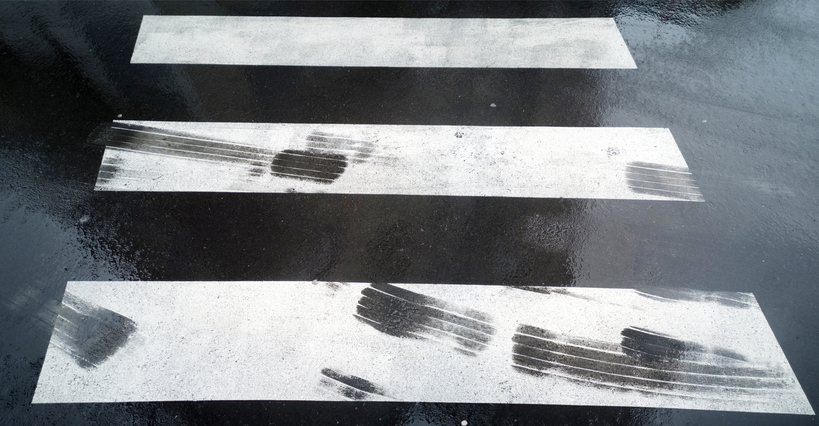 tire tracks in dangerous zebra crossing