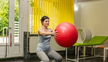 Woman practicing on a fitness ball.