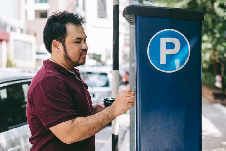 Man using parking meter