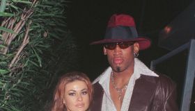 New Laker Dennis Rodman celebrates his first winning game out on the town at GOODBAR with wife Carmen Electra...