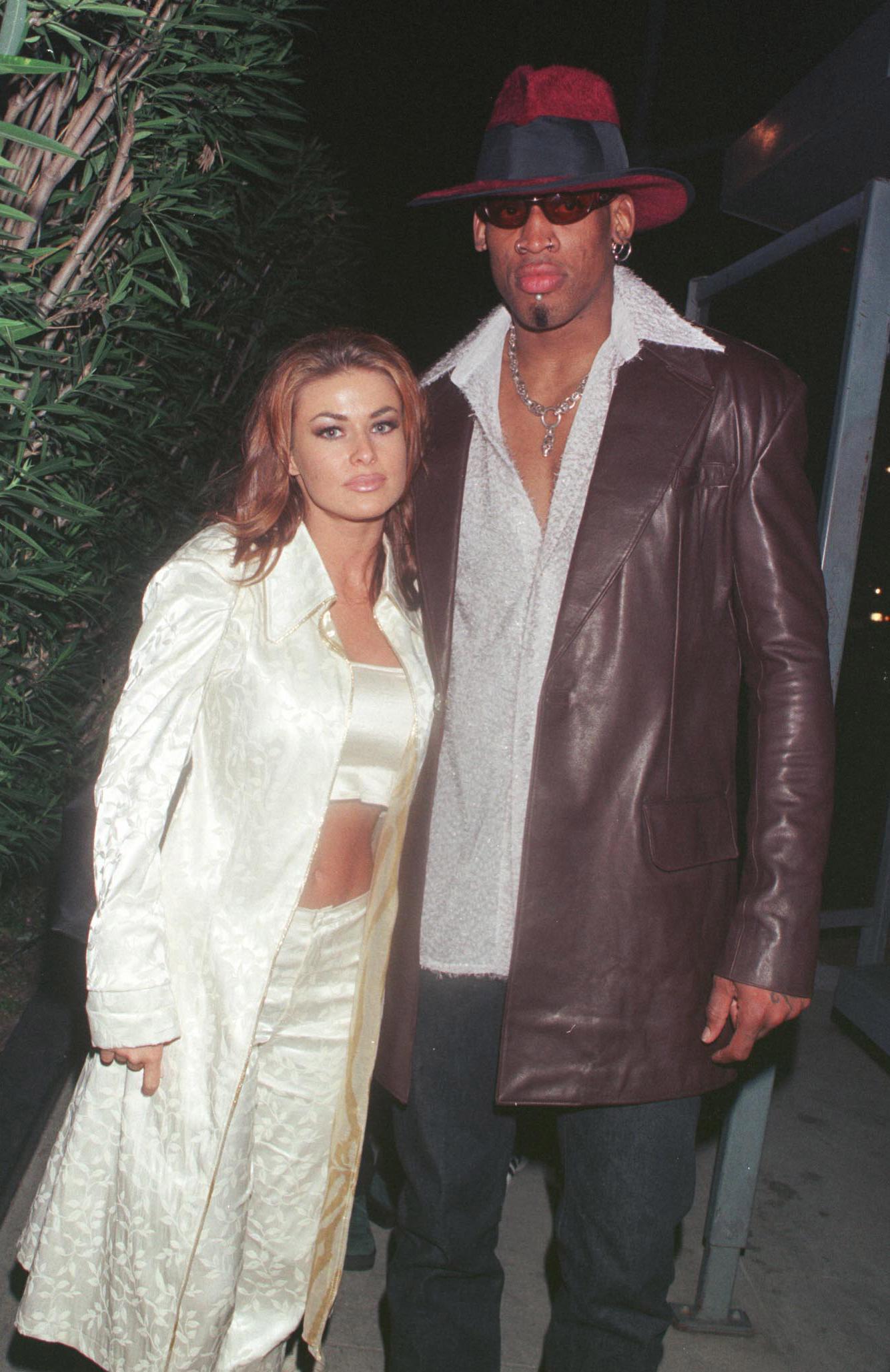 New Laker Dennis Rodman celebrates his first winning game out on the town at GOODBAR with wife Carmen Electra...