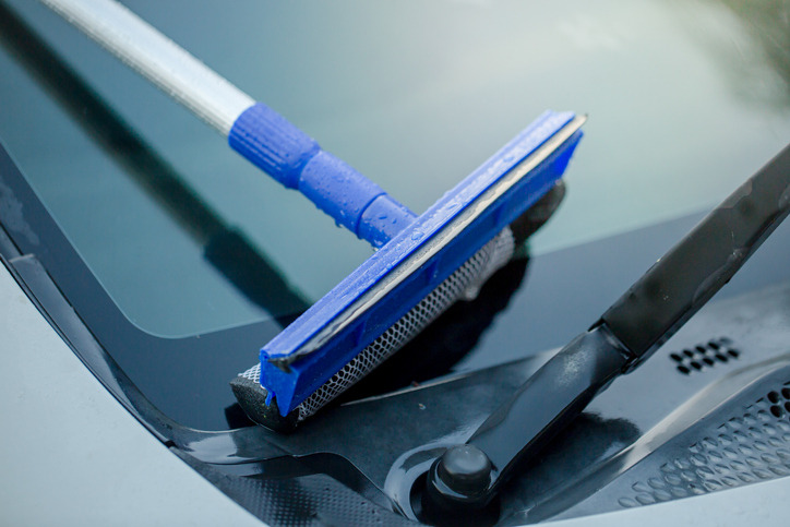 Close-Up Of Squeegee Over Car Windshield