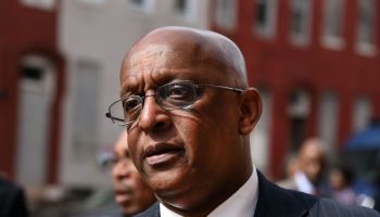 Baltimore's 51st mayor spends his first full day on the job 527 miles away, his phone ringing nonstop
