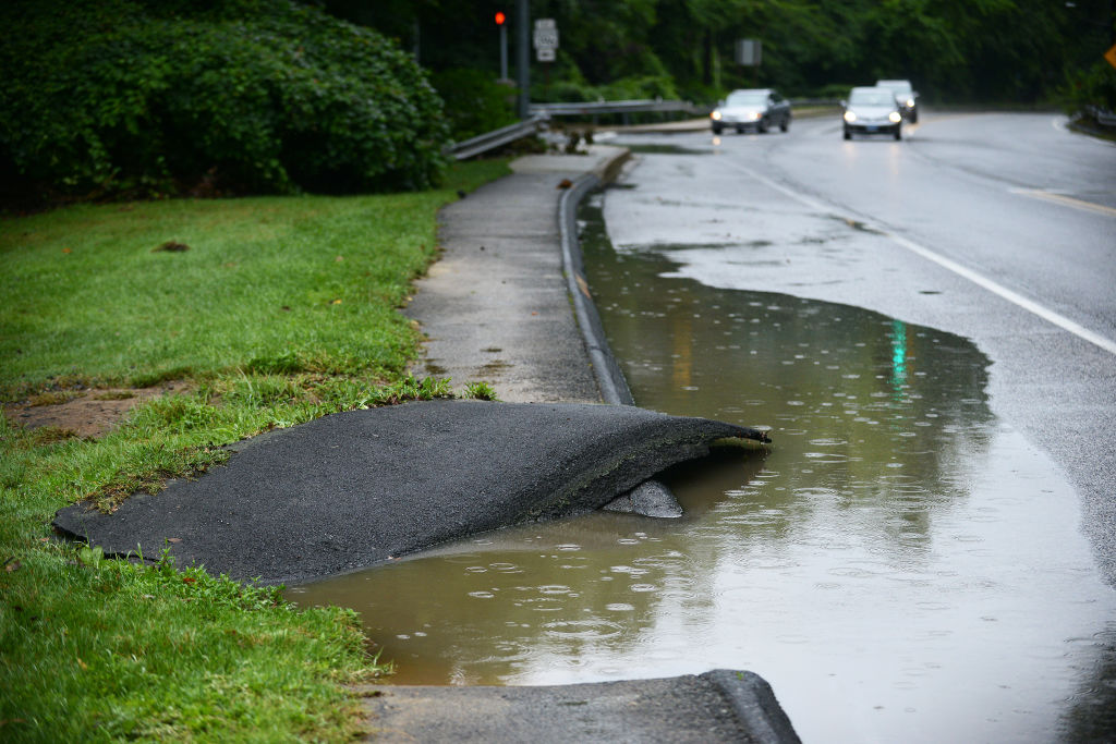 BETHESDA, MD - JULY 8: Parts of the sidewalk were washed away