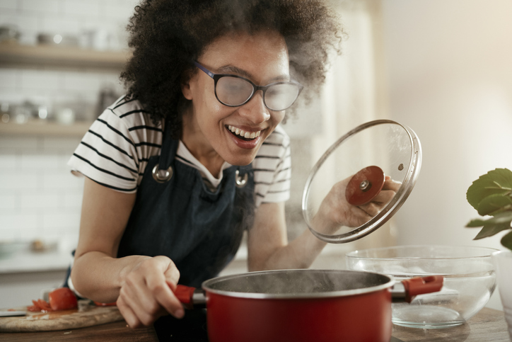 Beautiful woman cooking at home.