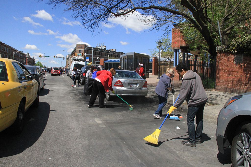Baltimore residents clean streets following riot over death of Freddie Gray...