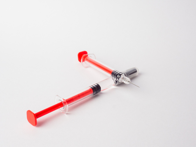 Two syringes on a white background