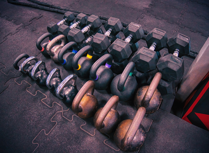 Dumbbells and kettlebells on a gym's floor