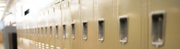 diminishing perspective of row of traditional metal school lockers