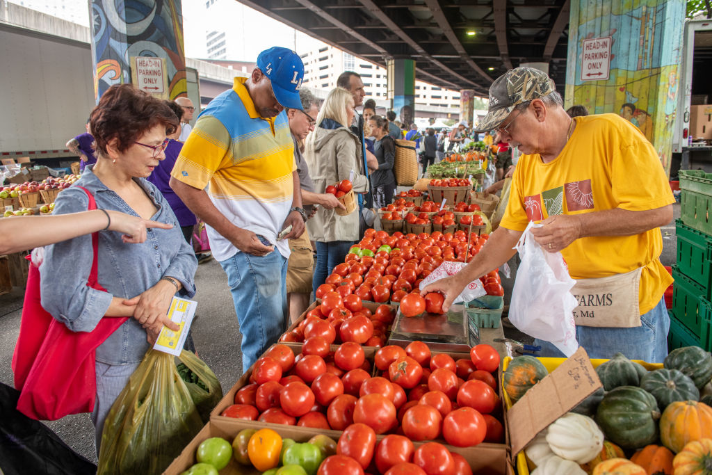 Customers shopping at the farmers market under JFX in Baltimore, MD