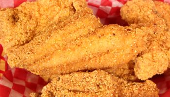 Closeup shot of fried catfish in a diner basket