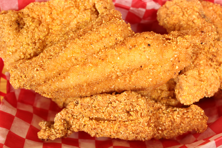 Closeup shot of fried catfish in a diner basket