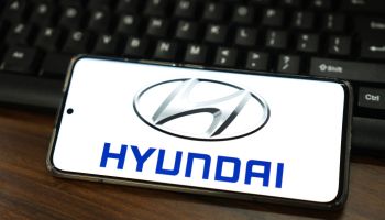 In this photo illustration, a Hyundai Motor logo is...
